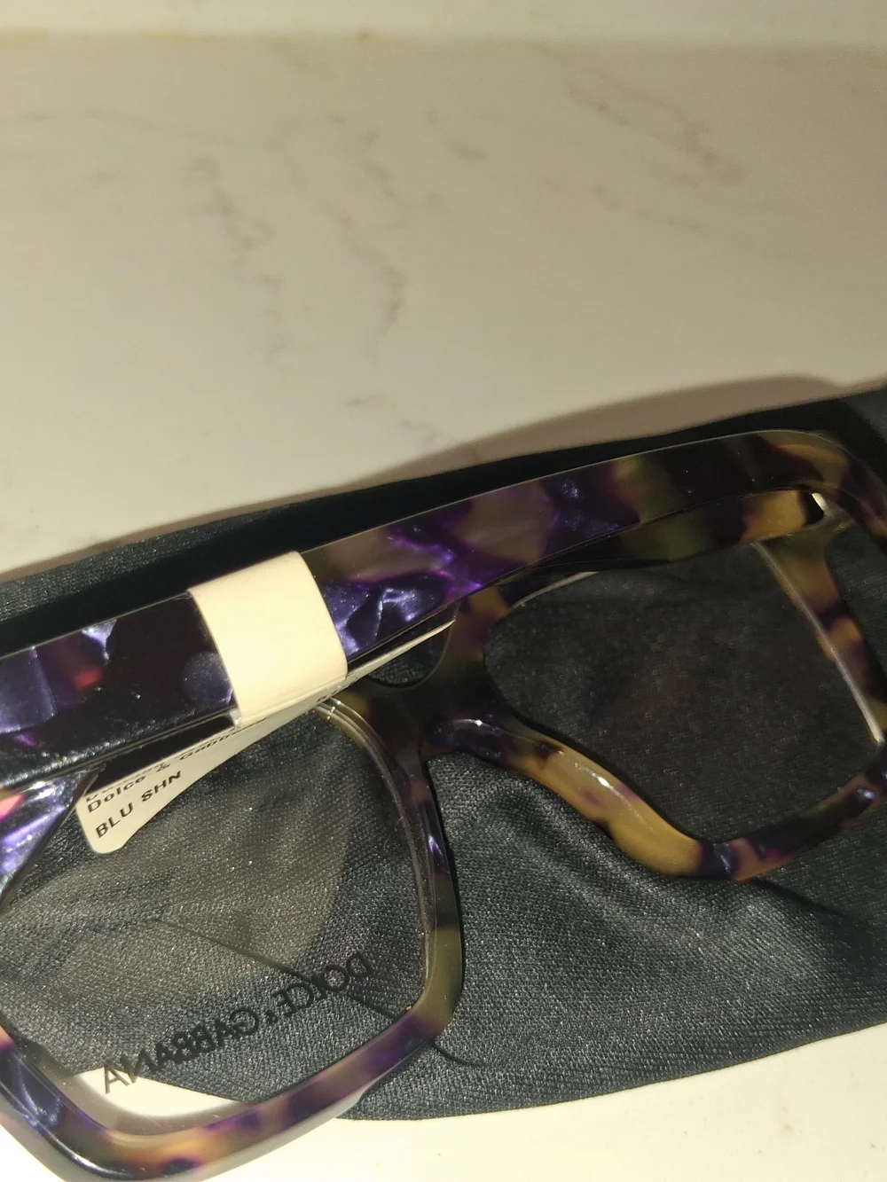 Dolce & Gabbana DG3395 eyeglasses feature a striking Havana Blue Pearl tortoises